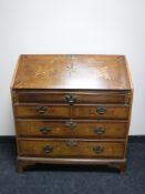 A late 19th century oak bureau on bracket feet