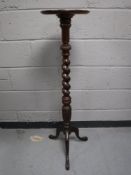 A mahogany barley twist plant stand on tripod base