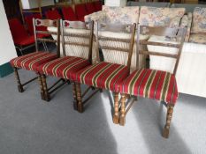 Four oak dining chairs in red striped covering