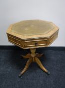 An octagonal leather top drum table