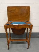 A 19th century walnut sewing table, width 62 cm.