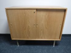 A pair of Danish teak sliding door office cupboards