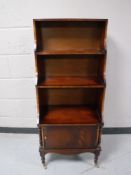 A Regency style bookcase fitted with a cupboard below