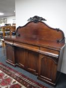 A Victorian mahogany four door sideboard fitted three drawers