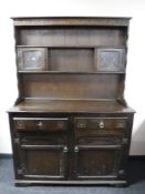 An oak Welsh dresser CONDITION REPORT: 180cm high by 124cm wide by 48cm deep.