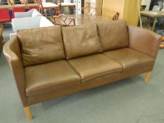 A Danish brown leather three seater settee