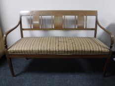 An inlaid mahogany scroll arm settee