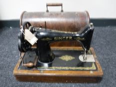 A cased Singer hand sewing machine