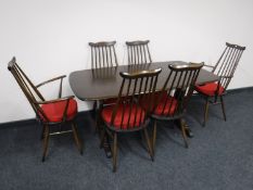 An Ercol elm refectory dining table and six high back chairs