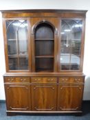 A mahogany display cabinet fitted with cupboards beneath