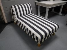 A contemporary chaise longue in striped covering