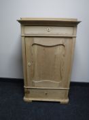 An early 20th century stripped pine cabinet fitted two drawers