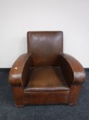 An early 20th century brown leatherette armchair