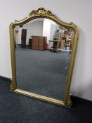 An ornate gilt framed overmantel mirror