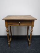 An early 20th century oak side table fitted a drawer