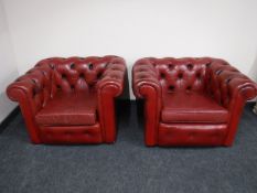 A pair of red button leather Chesterfield armchairs