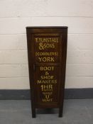 An early 20th century and later oak shoe cupboard,
