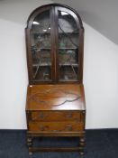 An early 20th century oak domed topped bureau bookcase