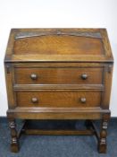 A carved oak writing bureau