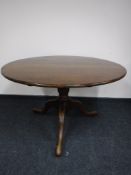 An oak circular tilt top breakfast table