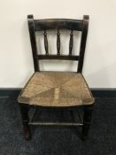 An antique child's rush seated chair