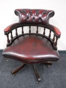 A red button leather captain's armchair