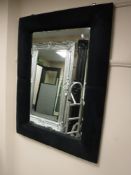 A black cushion framed mirror and a black gloss side table (2)