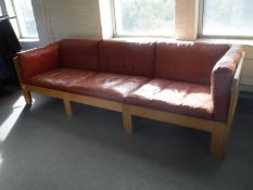 An oak framed mid 20th century three seater settee with Burgundy leather cushions