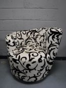 A contemporary swivel armchair,
