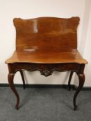 A 19th century mahogany tea table on cabriole legs,