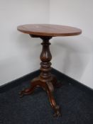 An oval mahogany occasional table on three way tripod base