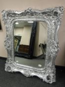 A very ornate silvered mirror,