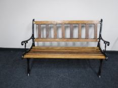 A cast iron and teak garden bench