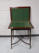 An early 20th century mahogany foldover games table