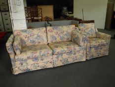 A two seater settee and armchair in floral print
