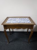 An early 20th century oak kitchen table fitted a drawer