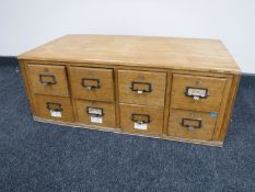 An early 20th century oak eight drawer index chest