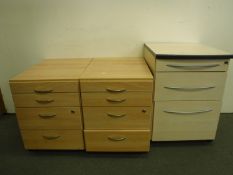 A pair of four drawer under desk chests and one other