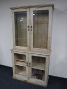 An antique pine double door glazed bookcase