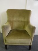 A mid 20th century armchair upholstered in gold fabric