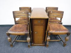 An oak drop leaf storage table and four oak chairs (odd)