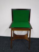 A Victorian inlaid mahogany foldover games table