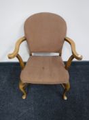 A 20th century beech armchair on cabriole legs