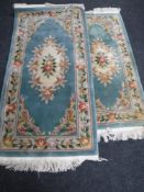 Two fringed Chinese rugs on turquoise ground CONDITION REPORT: 1st - 200cm by 95cm.