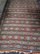 A fringed chain stitched rug of geometric design