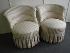 A pair of bedroom chairs in striped covering