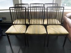 Six teak rail back dining chairs