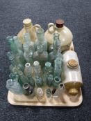 A tray of vintage glass bottles, stone ware water bottle,