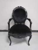 A black French salon armchair,