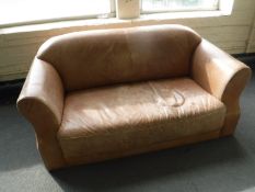 A Danish 1970's brown leather two seater settee